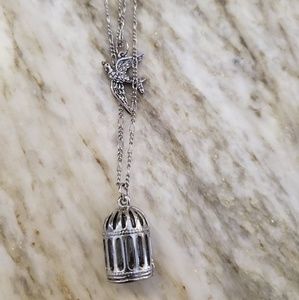 Silver bird and cage necklace.